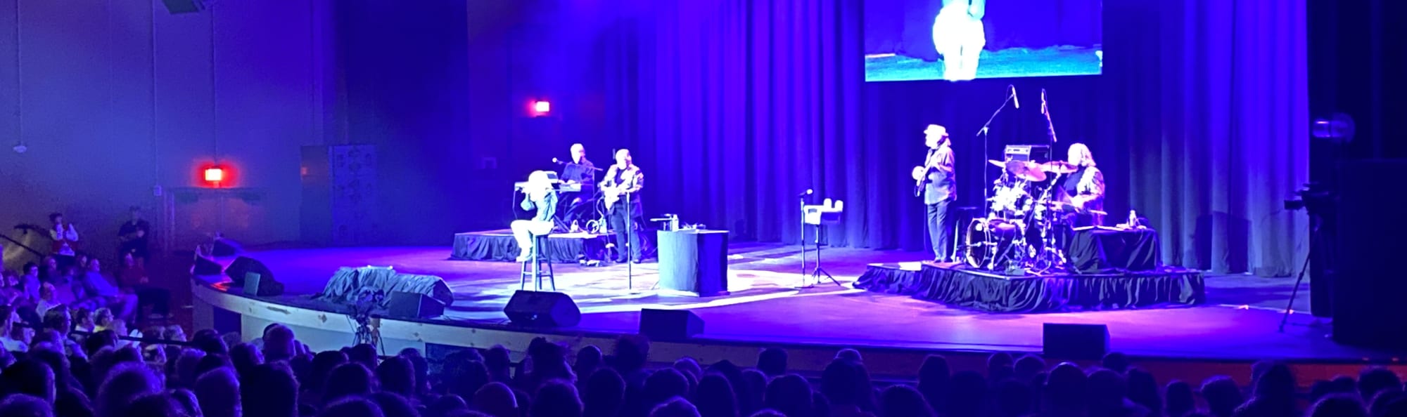 signer on stage in chair washed out by the lights Omaha